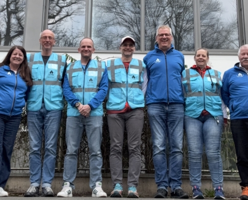 Gruppe von Menschen in Blauen Jacken